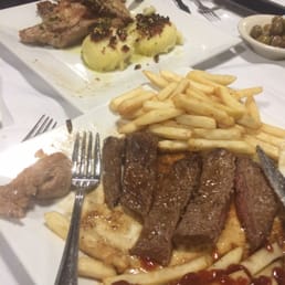 a plate of steak and french fries