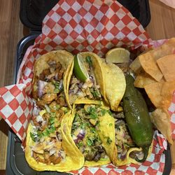 Tacos El Pariente - Tacos: 2 Al Pastor, 2 Asada, 2 Carnitas.  Yum.  Beware: the jalapeño is always extra spicy here.