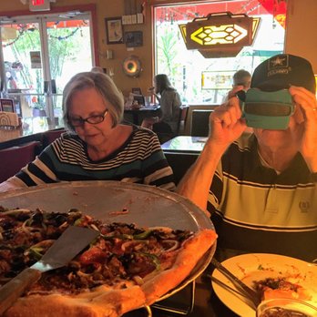 Satchel's Pizza - Our excellent pizza & salad!  ft. My Papaw looking through the viewmaster at the dessert menu - Pizza Near Me - Gainesville, Florida