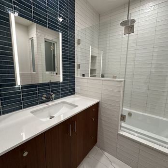 Ideal Builders - After - Bathroom 1 - modern vanity and tub - General Contractors Near Me