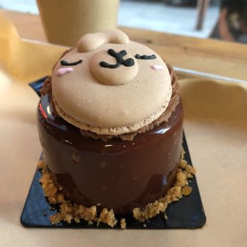 Bibble & Sip - The yummy hazelnut mango mousse cake with a nasty stale (cute) llama macaron. - Coffee & Tea Near Me - New York, New York Bibble & Sip - The yummy hazelnut mango mousse cake with a nasty stale (cute) llama macaron. - Coffee & Tea Near Me - New York, New York