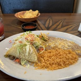 Bean tostada with ground beef taco and beans and rice.