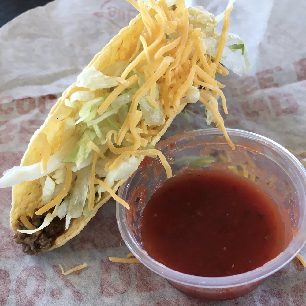 Taco Bueno - This "party" taco at slightly less cost of a regular crispy taco lacks tomatoes, which can be easily added from the condiment bar. - Tex-Mex Near Me - Owasso, Oklahoma