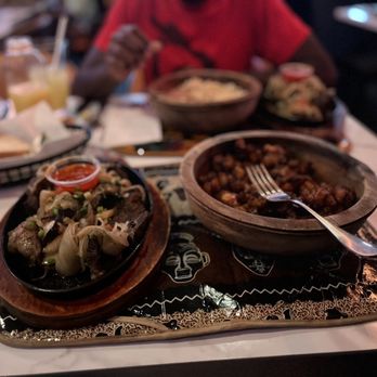 Yop City Resturant - a plate of food on a table - African Near Me - Bronx, New York Yop City Resturant - a plate of food on a table - African Near Me - Bronx, New York