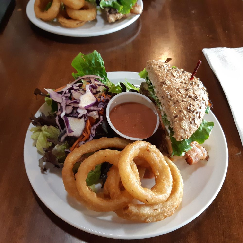 Burger Heaven - Backyard burger and two sides (salad and upgraded onion rings) split in two - Burgers Near Me - New Westminster, British Columbia