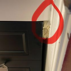 The Frankfort Handyman - Squeeze the cement like substance between the wall and the vanity. down the vanity Can be removed with acetone, but will Wreck the vanity