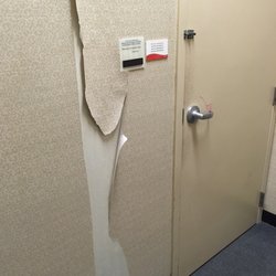 JCPenney - Torn wall paper in women's fitting room