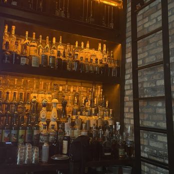 Copper Shaker - More spirit shelving with a ladder to reach the extra bottles way up top - Cocktail Bars Near Me - St Petersburg, Florida