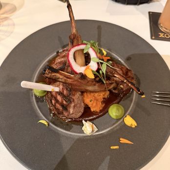 Xochi - Costillas de Borrego -- Australian lamb chops in a tamarind mole, with potatoes. - Mexican Near Me - Houston, Texas Xochi - Costillas de Borrego -- Australian lamb chops in a tamarind mole, with potatoes. - Mexican Near Me - Houston, Texas