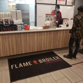 The Flame Broiler - a man standing in front of a counter - Asian Fusion Near Me - Tulsa, Oklahoma