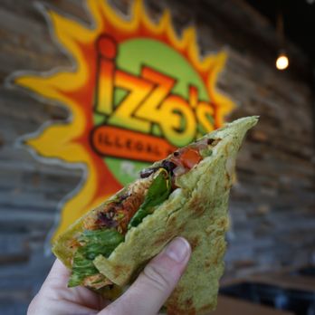 Izzo's Illegal Burrito - a hand holding a burrito - Mexican Near Me - Lafayette, Louisiana Izzo's Illegal Burrito - a hand holding a burrito - Mexican Near Me - Lafayette, Louisiana