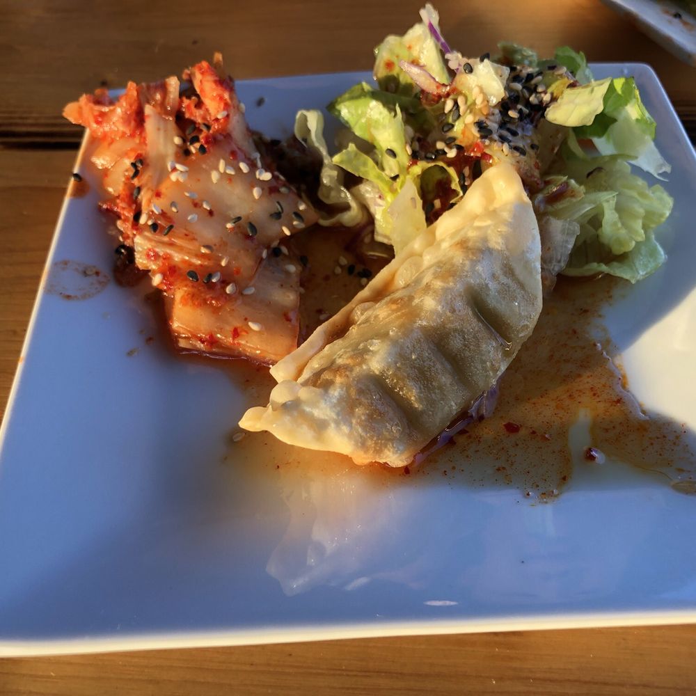 Ryu's Kitchen - Side plate that accompanies dinner entrees: Kimchi, Sesame salad, chicken dumpling. - Korean Near Me - Fort Wayne, Indiana Ryu's Kitchen - Side plate that accompanies dinner entrees: Kimchi, Sesame salad, chicken dumpling. - Korean Near Me - Fort Wayne, Indiana