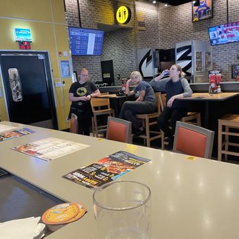 Buffalo Wild Wings - people sitting at a bar - Chicken Wings Near Me - Webster, New York Buffalo Wild Wings - people sitting at a bar - Chicken Wings Near Me - Webster, New York