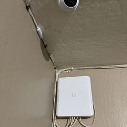 Smart Tech Installations - Garage: Unifi Flex Utility enclosure with Flex Switch inside (serving 4 exterior cameras) and a G5 Turret camera.