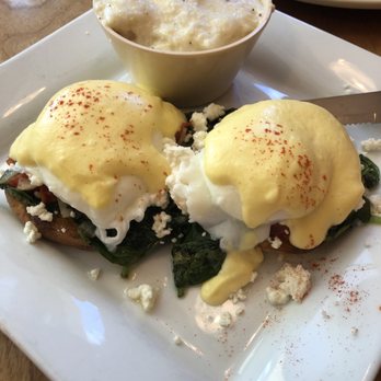Mulberry Lane Cafe - Homemade hollandaise, poached eggs on top of sautéed spinach, onions, tomatoes and feta cheese over English muffin. Side of grits. - Breakfast & Brunch Near Me - Melbourne, Florida Mulberry Lane Cafe - Homemade hollandaise, poached eggs on top of sautéed spinach, onions, tomatoes and feta cheese over English muffin. Side of grits. - Breakfast & Brunch Near Me - Melbourne, Florida