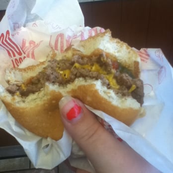 McDonald's - a hand holding a half eaten sandwich - Burgers Near Me - Burlington, Iowa McDonald's - a hand holding a half eaten sandwich - Burgers Near Me - Burlington, Iowa