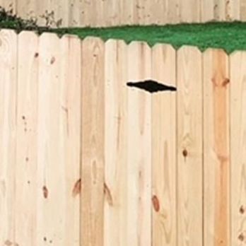 Pleasant Valley Fencing - a wooden fence with black holes - Fences & Gates Near Me Pleasant Valley Fencing - a wooden fence with black holes - Fences & Gates Near Me