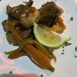 Harmony Cafe - Ribeye cornbread topped with calamari and shrimp and vegetables