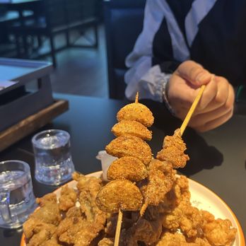 Xinjiang  BBQ - Garlic skewers and crispy pork appetizer on the dish - Asian Fusion Near Me - San Diego, California