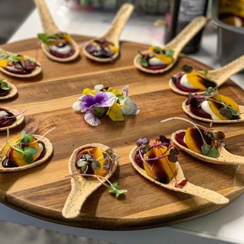 Chef Lucy - a platter of small appetizers on wooden spoons - Caterers Near Me