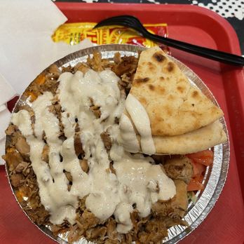 The Halal Guys - Small chicken platter drowned in white sauce alongside a White Sauce Packet To-Go - Halal Near Me - Fort Lee, New Jersey