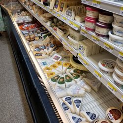Capitol Supermarket - Cheese section. Check out the brie selection and smoked Gouda among others!