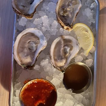 Sea Wolf Tybee - Oyster on the half with bourbon berry mignonette and cocktail sauce - Wine Bars Near Me - Tybee Island, Georgia Sea Wolf Tybee - Oyster on the half with bourbon berry mignonette and cocktail sauce - Wine Bars Near Me - Tybee Island, Georgia
