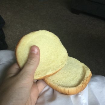 Wendy's - a hand holding a piece of bread - Fast Food Near Me - Hillsboro, Oregon