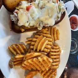 Warren's Restaurant and Bar - Philadelphia Cheesesteak sandwich and waffle fries.