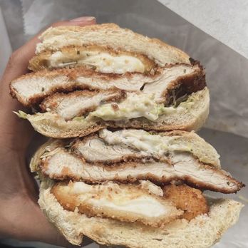Sammy’s Subs - Chicken Cutlet - A sandwich with fried chicken, creamy sauce, and bread, cut in half to reveal the fillings inside. - Sandwiches Near Me - Wayne, New Jersey
