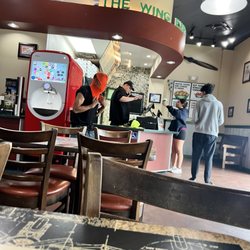 Wingstop - Homeless individual with the orange ski mask with his lime green hat and clothing on the counter.