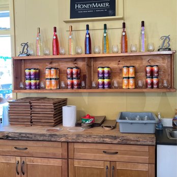 HoneyMaker - jars of honey on a shelf above a sink - Wine Tasting Room Near Me - Kennebunk, Maine