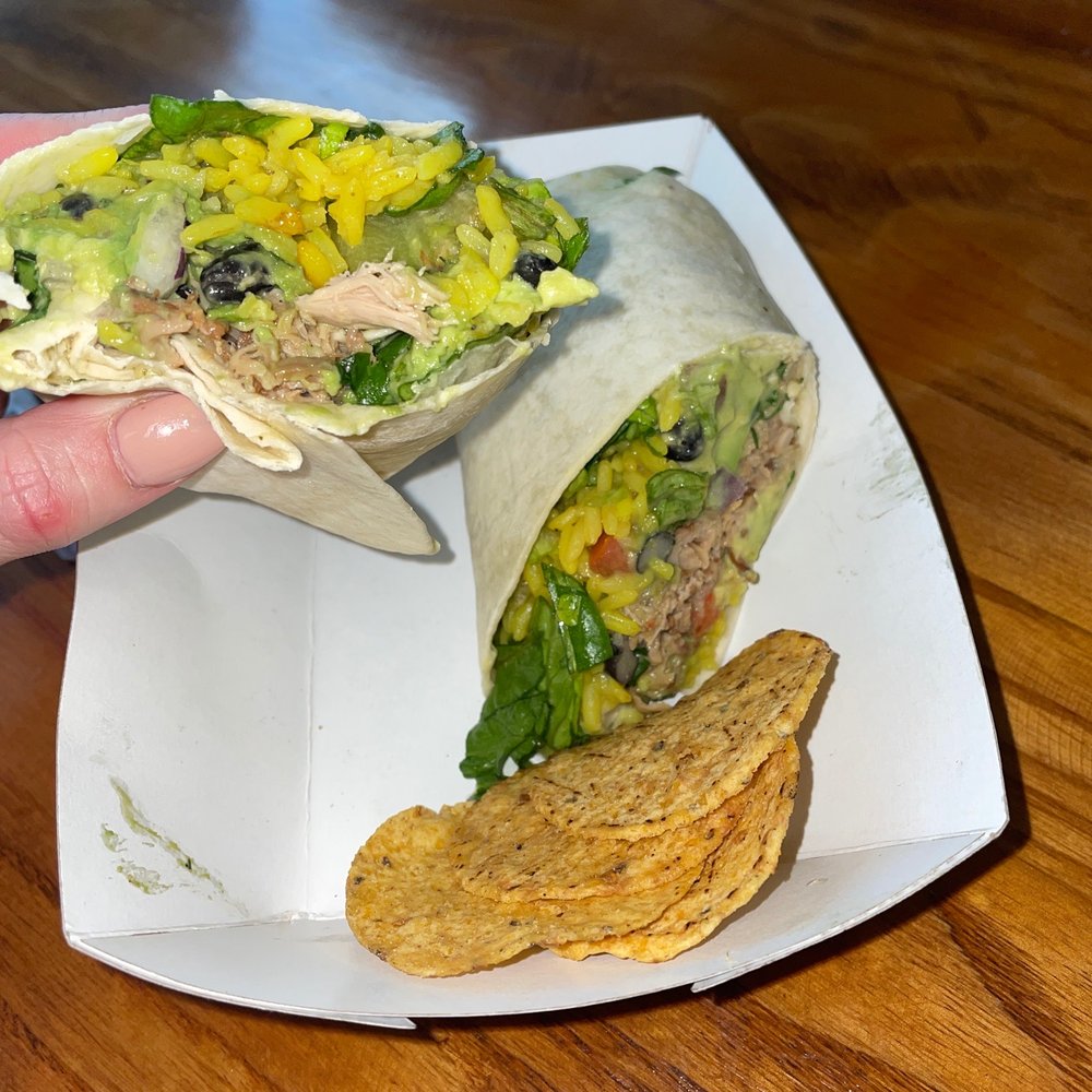 Guaca Go - a hand holding a burrito and chips - Fast Food Near Me - Boynton Beach, Florida Guaca Go - a hand holding a burrito and chips - Fast Food Near Me - Boynton Beach, Florida