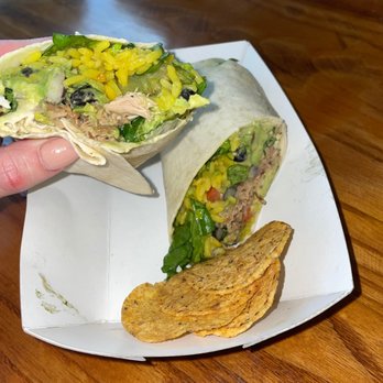 Guaca Go - a hand holding a burrito and chips - Fast Food Near Me - Boynton Beach, Florida