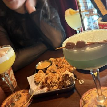 Paper Fan Cocktail Bar - Lotus pond. Popcorn chicken. Game of ming and lychee blossom in the top corner - Cocktail Bars Near Me - Seattle, Washington