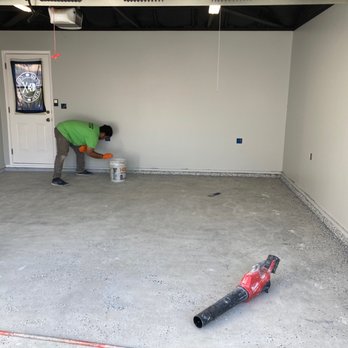 WOW Metallic - Helper and Charlie throwing vinyl specs on edges of floor. - Flooring Near Me