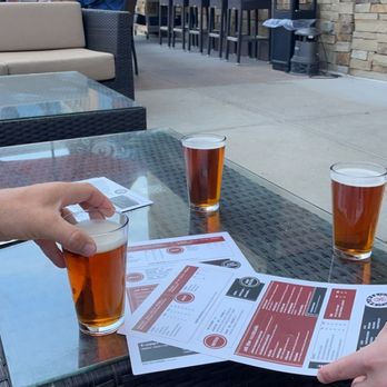 Saints Pub + Patio City Center - a person handing a drink to another person - Sports Bars Near Me - Lenexa, Kansas Saints Pub + Patio City Center - a person handing a drink to another person - Sports Bars Near Me - Lenexa, Kansas