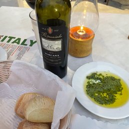Complimentary bread, pesto dip and a bottle of red wine Complimentary bread, pesto dip and a bottle of red wine
