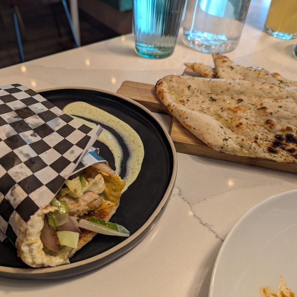 The Roaring Rolls - Malai Chicken Kathi Roll and a side of Garlic Naan - Indian Near Me - Canmore, Alberta The Roaring Rolls - Malai Chicken Kathi Roll and a side of Garlic Naan - Indian Near Me - Canmore, Alberta