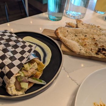 The Roaring Rolls - Malai Chicken Kathi Roll and a side of Garlic Naan - Indian Near Me - Canmore, Alberta The Roaring Rolls - Malai Chicken Kathi Roll and a side of Garlic Naan - Indian Near Me - Canmore, Alberta