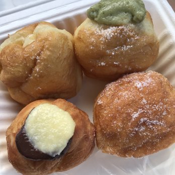 Kauai Bakery - Cream filling, matcha, plain and ending with chocolate malasadas (top left going clockwise) - Bakeries Near Me - Lihue, Hawaii Kauai Bakery - Cream filling, matcha, plain and ending with chocolate malasadas (top left going clockwise) - Bakeries Near Me - Lihue, Hawaii