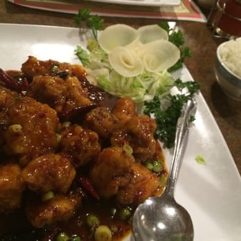 Leo's Kitchen - General tso extra spicy with white rice. And a flowery thing made from a vegetable - Chinese Near Me - Roseville, California