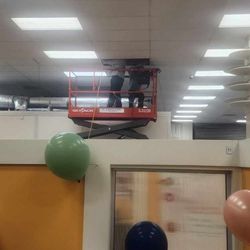 Active Pest Control - Termite eradication in office building with high ceilings using a man lift.