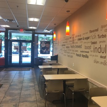 Dunkin' -  the inside of a restaurant with tables and chairs - Donuts Near Me - Frederick, Maryland