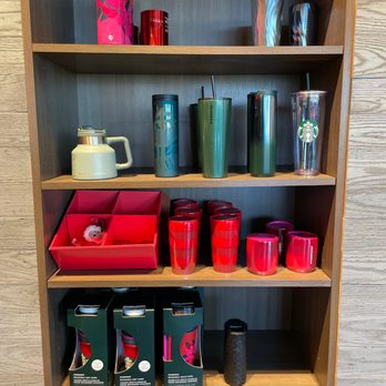 Starbucks - a shelf with cups and mugs on it - Coffee & Tea Near Me - Tucson, Arizona
