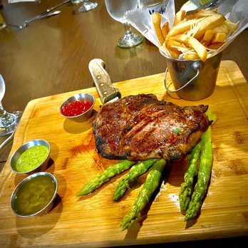 Aji 10 Latin Cuisine - Ribeye steak served with fries and asparagus. - Latin American Near Me - Norwalk, Connecticut