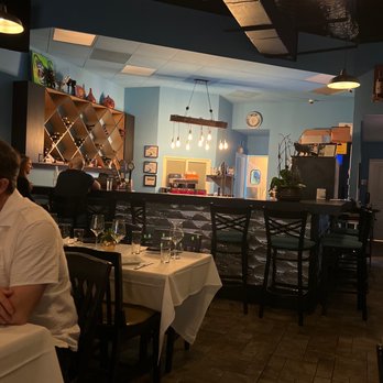 Swirl Wine Bistro - a man sitting at a table in a restaurant - Wine Bars Near Me - Margate, Florida Swirl Wine Bistro - a man sitting at a table in a restaurant - Wine Bars Near Me - Margate, Florida