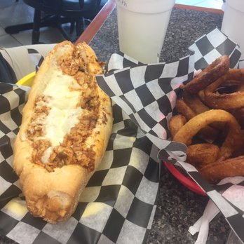 Rick's Cheesesteak Shop - Chicken pizza steak sandwich and an order of onion rings. - Cheesesteaks Near Me - Williamsburg, Virginia