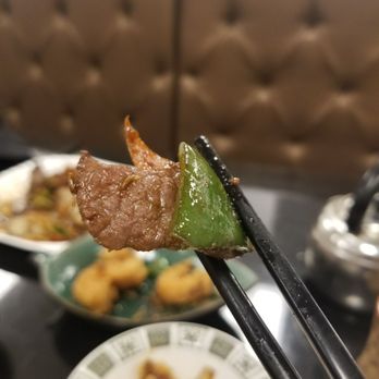 Yuan Lei - chopsticks holding up a piece of meat - Chinese Near Me - Montreal, Quebec