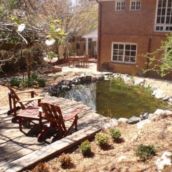 Aquaflora Landscapes - This pond has a stream, waterfall, lights, planting and a reclaimed timber coffee deck - Landscaping Near Me